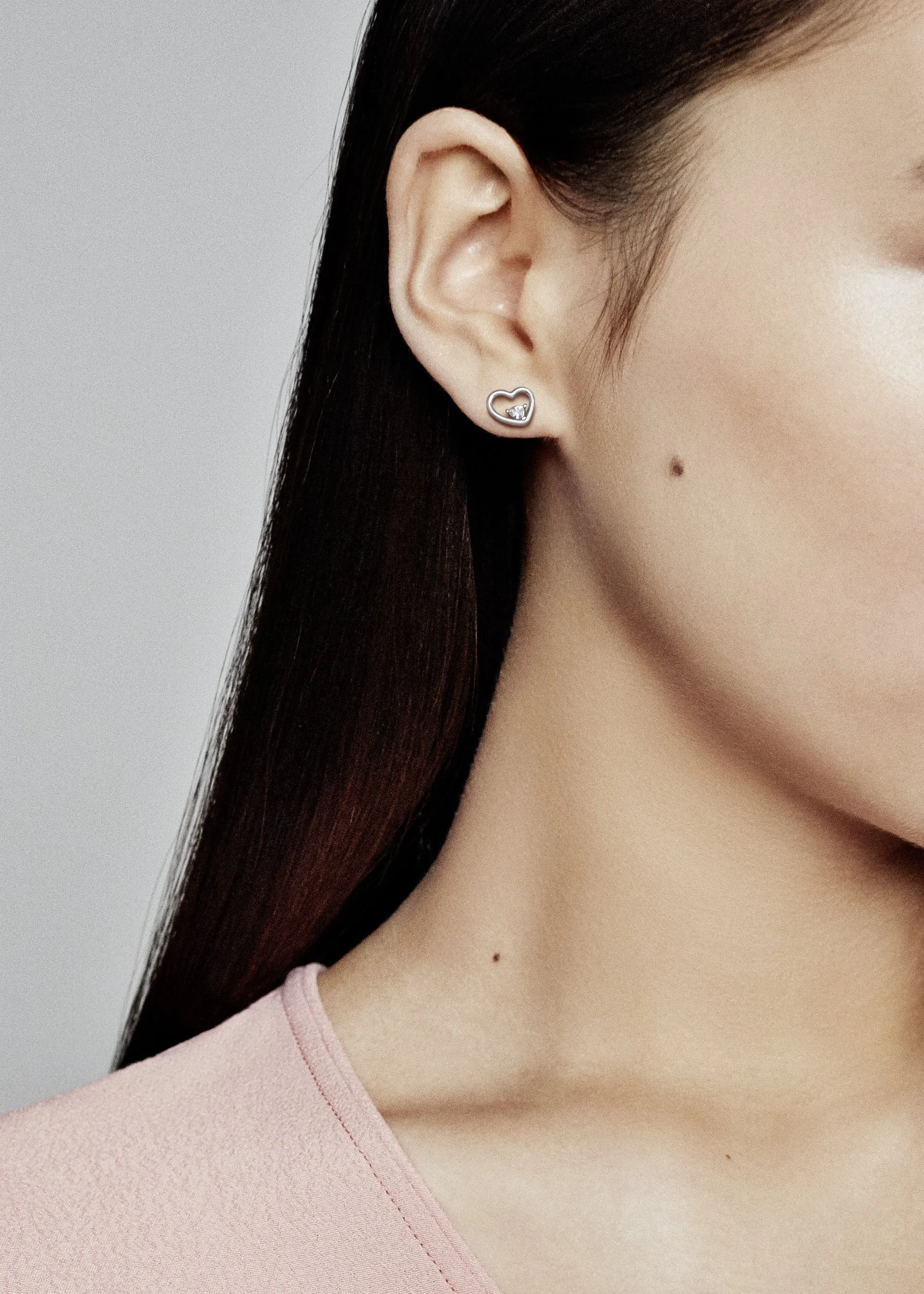 Asymmetrical heart stud earrings with clear cubic zirconia